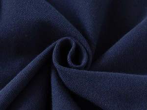 Macro shot of navy blue pique knit fabric showing breathable texture and premium cotton fibers
