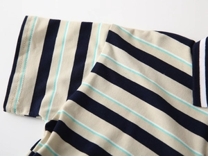 Detailed view of kids striped polo shirt featuring fine stitching and knit cotton texture