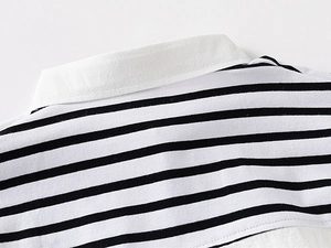 Detail shot of the black and white striped knit shirt with a crisp white cotton collar
