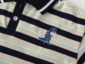 Close-up of navy blue and mint green striped polo shirt with dinosaur embroidery