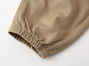 Macro view of elastic ribbed cuffs on khaki twill cotton trousers for children