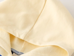 Detailed close-up of yellow hoodie hood showing fine French terry cotton texture