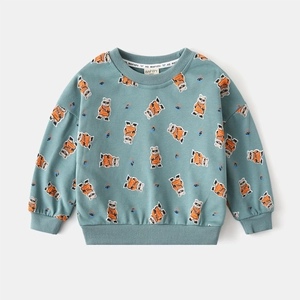 Detailed close-up of greyish green sweatshirt with cartoon bear prints and ribbed collar