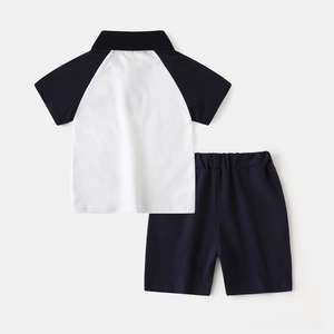 Detail of boys' polo set with black and white raglan sleeves and elastic waistband shorts