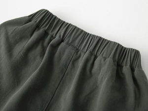 Detail view of boys' shorts featuring an elastic waistband with reinforced stitching