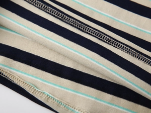 Detailed close-up of striped knit fabric showing high-quality stitching and texture