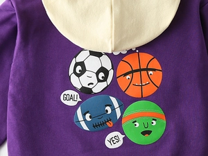 Detail of cartoon sports print on kids purple hoodie with soccer and basketball graphics