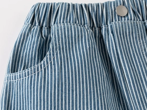 Detail of boys denim shorts showing elastic waistband with metal button and blue stripes