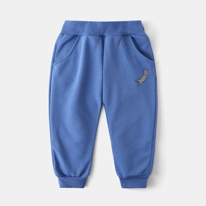 Detail of blue cartoon jogger pants with elastic waistband and ribbed cuffs for boys