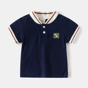 Detail view of navy polo shirt featuring dinosaur embroidery and striped ribbed collar
