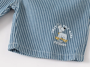 Detail of blue striped kids shorts featuring a cartoon dog print and vertical texture
