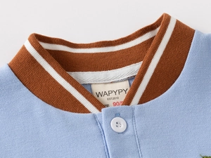 Close-up of light blue polo shirt with brown striped knit collar and button detail