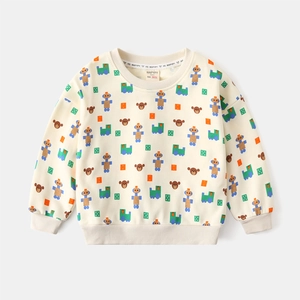 Close-up of cream sweatshirt with bear and train patterns and ribbed cuffs detail
