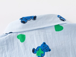 Close-up of the light blue shirt collar featuring cartoon bear and heart patterns