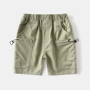 Detail of light green boys cargo shorts featuring elastic waist and drawstring pockets