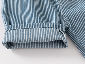 Detail shot of blue and white striped fabric hem with double stitching on kids denim shorts