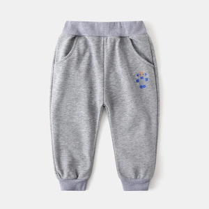 Detail of grey kids joggers with elastic waist and cute cartoon robot print on the leg