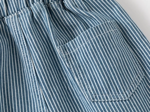 Detail of blue and white striped denim shorts with elastic waist and back pocket texture