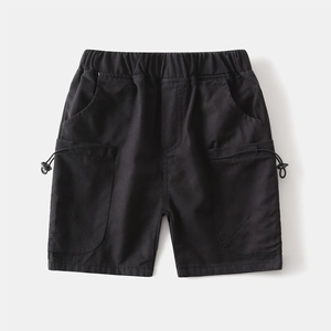 Detail of boys cargo shorts featuring elastic waistband and functional drawstring pockets