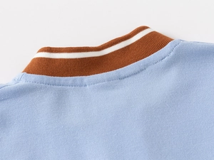 Close-up of the sky blue polo shirt showing pique fabric texture and striped collar