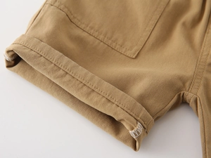 Detail of khaki cotton twill shorts showing cargo pocket and cuffed hem stitching
