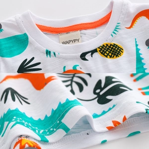 T-shirt blanc en coton flammé pour enfants avec imprimé dinosaure et col orange