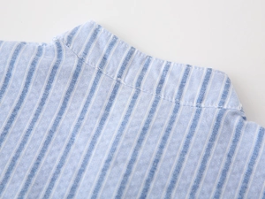 Detail of boys' blue striped shirt showing band collar and breathable cotton texture