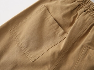 Detailed back view of khaki cargo shorts showing elastic waistband and large pockets