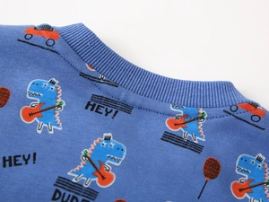 Detail of blue cotton sweatshirt with ribbed collar and colorful cartoon dinosaur print