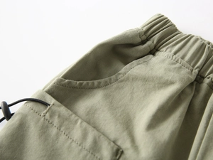 Macro detail of boys' cotton casual shorts featuring elastic waist and adjustable drawstring