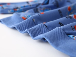 Detail of ribbed cuffs and cartoon print on blue cotton blend sweatshirt for boys