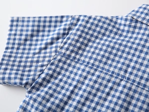 Close-up of blue and white checkered short sleeve shirt showing detailed shoulder stitching