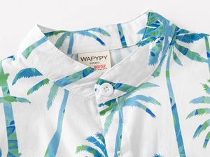 Detail of tropical palm print and mandarin collar on cotton boys' shirt