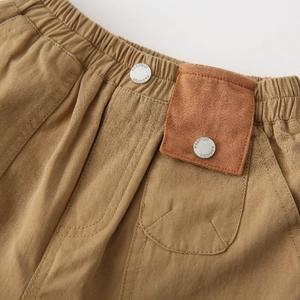 Boys khaki cotton shorts featuring elastic waist with fashion buttons and side patch detail