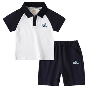 Boys summer two-piece outfit featuring white shark polo shirt and navy blue shorts