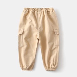 Detail of kids' khaki cargo pants with elastic waistband and large flap pockets