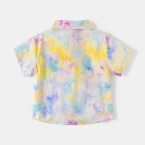 Flat lay of the back of a kids' short-sleeve shirt featuring a bright tie-dye pattern