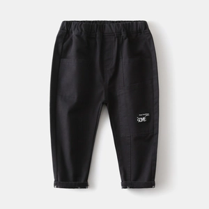 Detail of kids black casual cotton pants featuring elastic waist and letter patch print