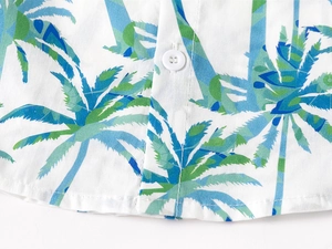 Detail of boys' summer shirt with coconut tree print and white four-hole button