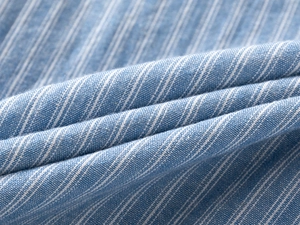 Close-up of breathable blue and white striped cotton-linen blend fabric for summer shirts