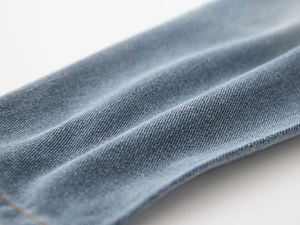 Macro shot of light blue denim fabric texture and twill weave for boys' jeans