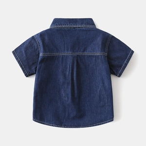 Back view of boys denim short sleeve shirt featuring contrast stitching and back pleat