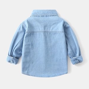 Back view of light blue washed denim shirt for boys with detailed yoke stitching and texture