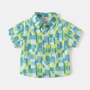 Detail of boys short sleeve shirt with abstract geometric patterns and chest pocket