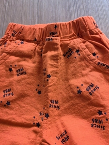 Orange kids cotton shorts with elastic waist featuring Since 1986 star print