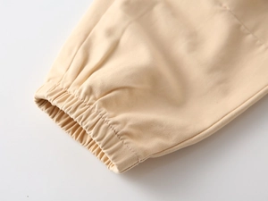 Detailed macro view of beige elastic cuffs and high-quality twill fabric texture