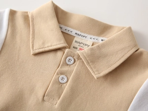 Detail of baby boy polo shirt showing the woven neck label and breathable cotton mesh fabric