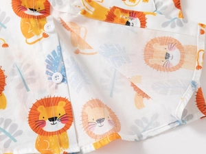 Close-up of kids' white cotton shirt featuring cartoon lion prints and white buttons
