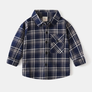 Close-up of navy blue plaid cotton flannel fabric and chest pocket on kid's shirt