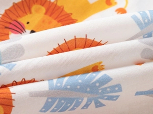 Close-up of soft cotton fabric featuring a cute cartoon lion print for kids shirts